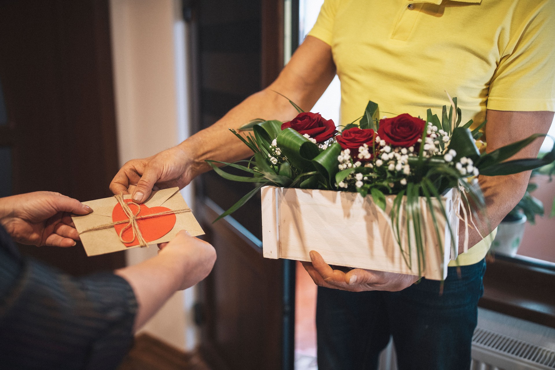 Woman receive flower bouquet from delivery person.